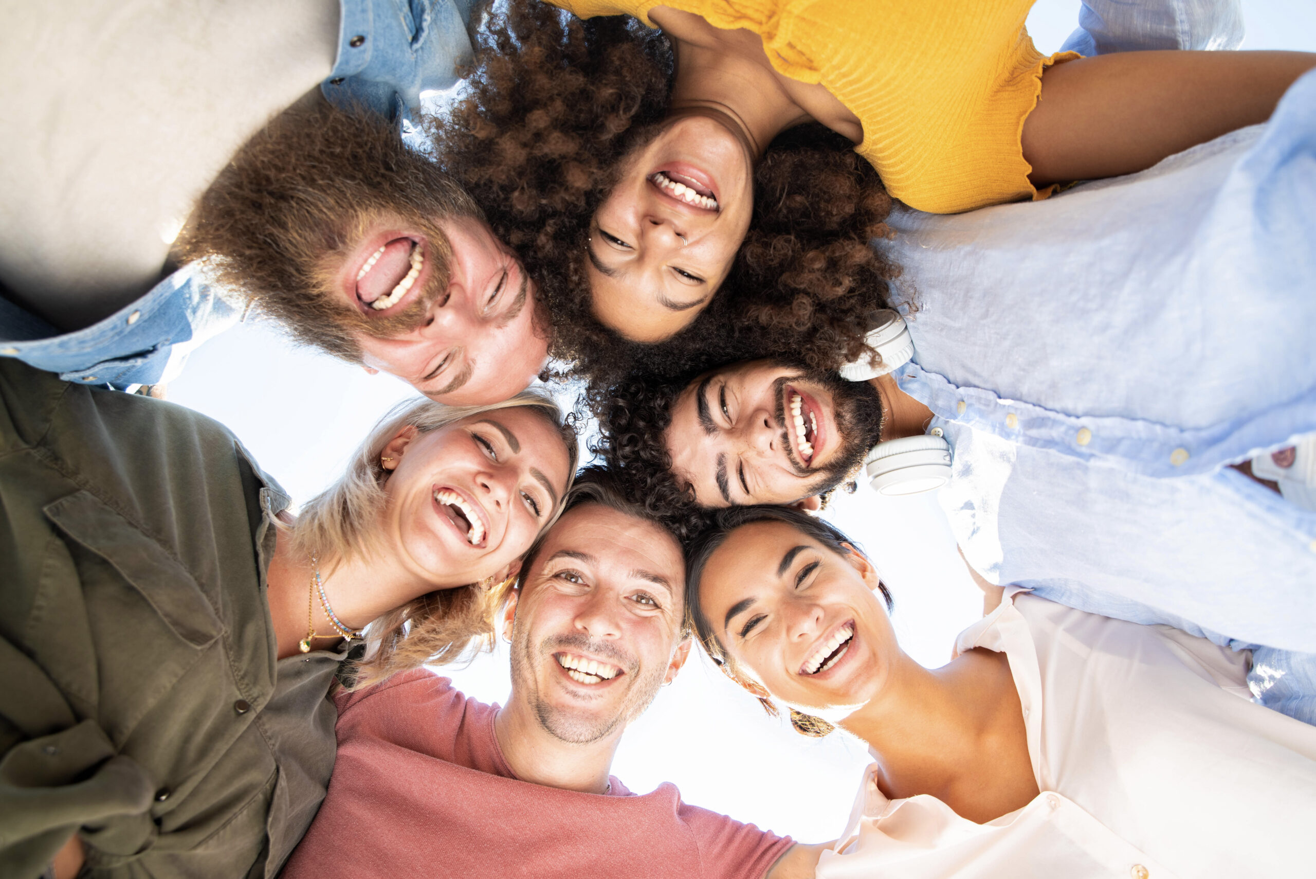 Multicultural group of friends in circle - Multi-ethnic young people taking selfie smiling at camera - Teamwork, friendship, community, university and human resources concept